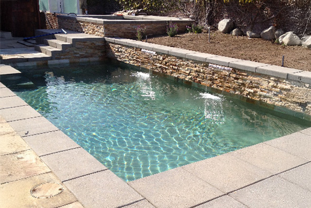pool-landscaping-waterfall tan hydrazzo swimming pool with water